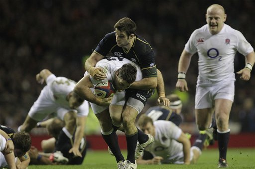 England's Brad Barritt, center left, is tackled by Scotland's Johnnie Beattie, center right, during their Six Nations rugby union match at Twickenham Stadium in London, Saturday, Feb. 2, 2013. (AP Photo/Sang Tan)