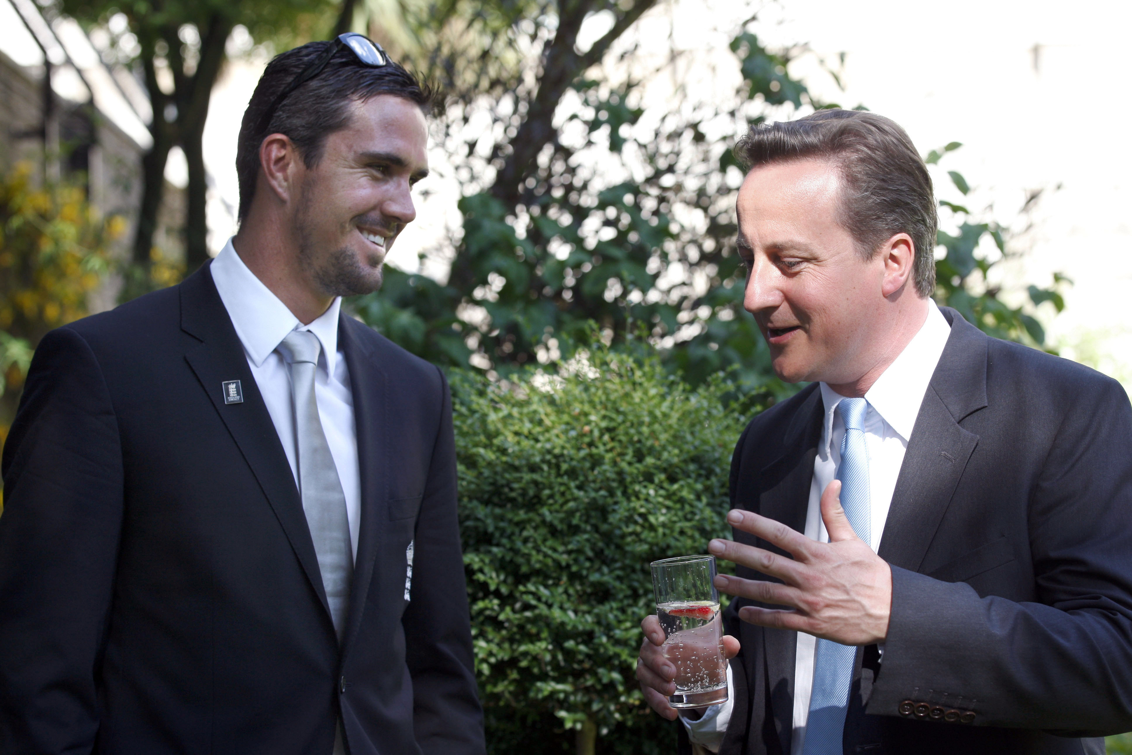 British Prime Minister David Cameron, right, talks to cricket player Kevin Pietersen during a reception for the Twenty20 World Cup winners, the England cricket team in the garden of 10 Downing Street in London, Monday, May 24, 2010. (AP Photo/Sang Tan, Pool)