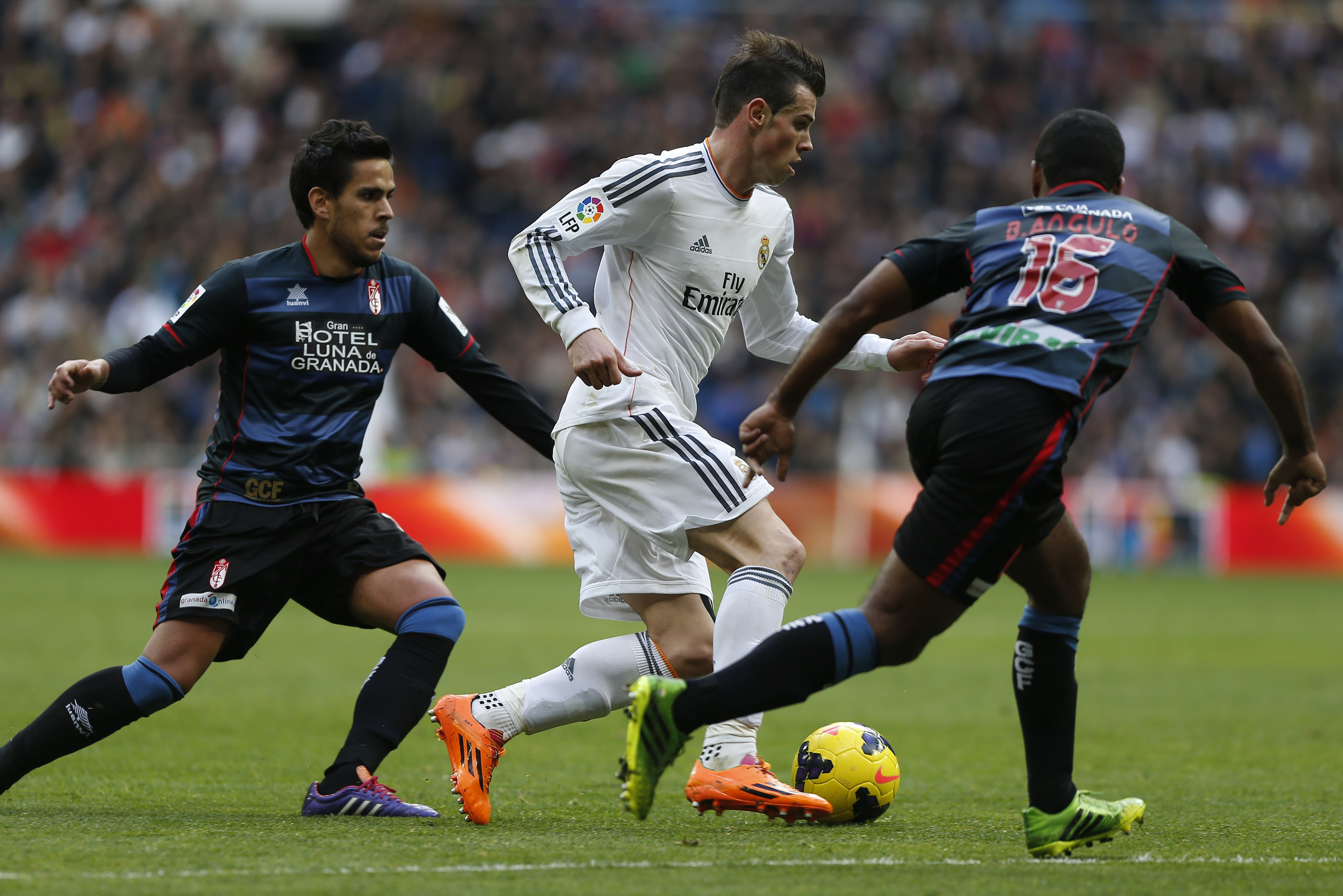 Real Madrid's Gareth Bale from Great Britain, centre, in action with Granada's Brayan Angulo, right, and Granada's Jose Luis Garcia