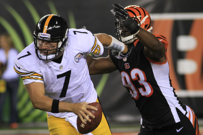 Pittsburgh Steelers quarterback Ben Roethlisberger (7) escapes a sack by Cincinnati Bengals defensive end Michael Johnson (93) in the second half of an NFL football game, Monday, Sept. 16, 2013, in Cincinnati. (AP Photo/Tom Uhlman)