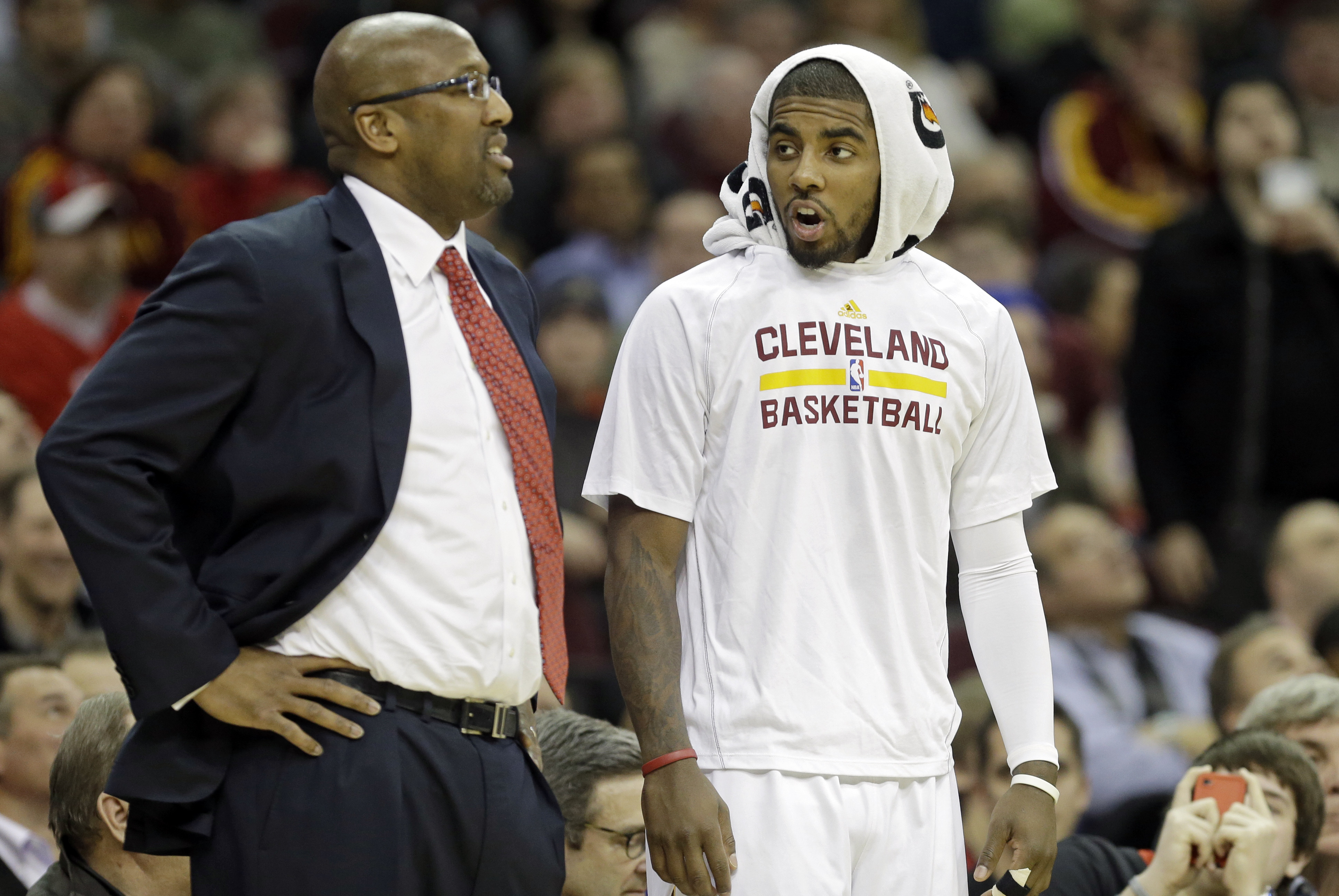 Cleveland Cavaliers' Kyrie Irving, right, talks to head coach Mike Brown during an NBA basketball game against the Los Angeles Lakers Wednesday, Feb. 5, 2014, in Cleveland. (AP Photo/Mark Duncan)