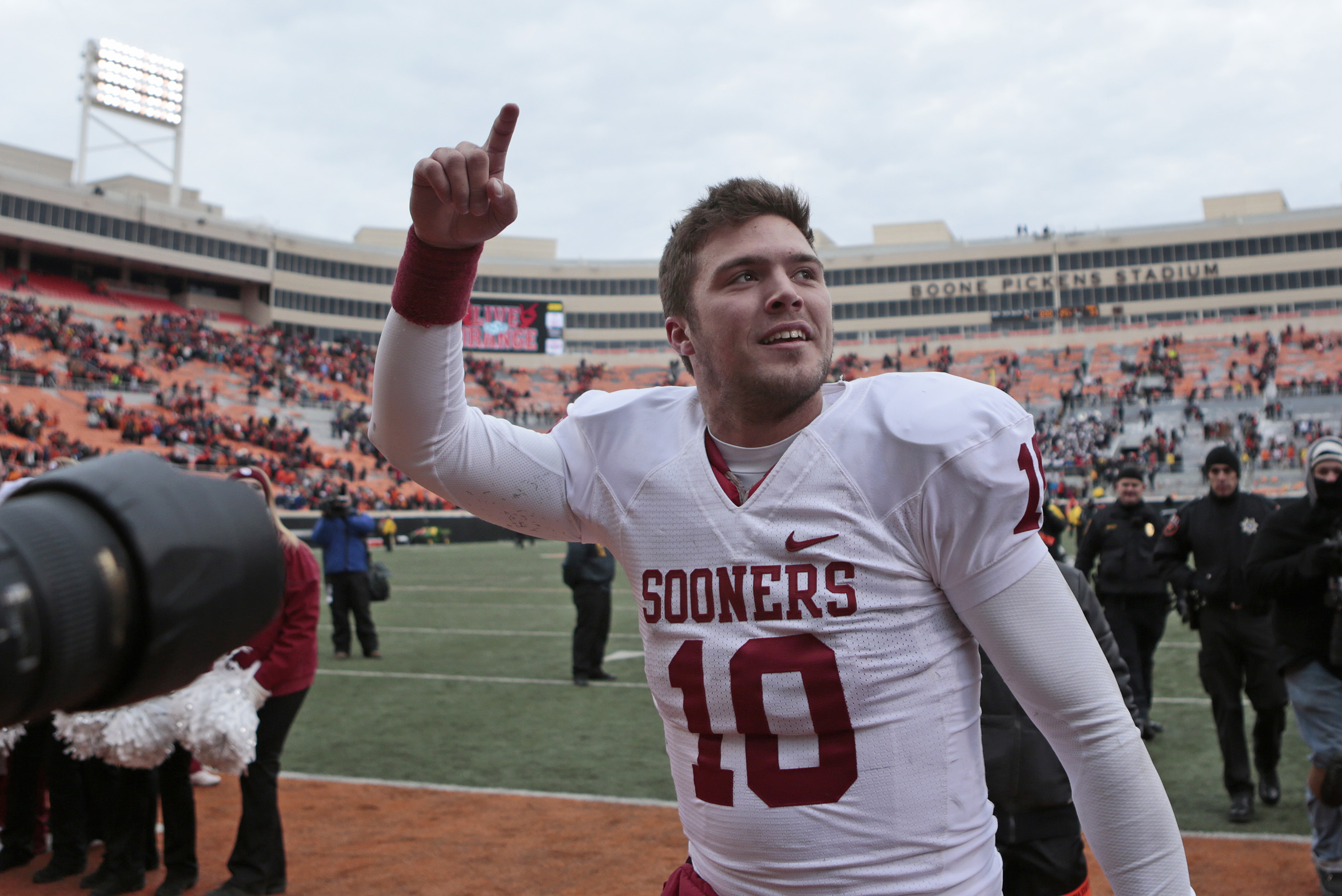 STILLWATER, OK - DECEMBER 7:    Quarterback Blake Bell #10 of the Oklahoma Sooners walks off the field after the game against the Oklahoma State Cowboys December 7, 2013 at Boone Pickens Stadium in Stillwater, Oklahoma. Oklahoma defeated Oklahoma State 33-24. (Photo by Brett Deering/Getty Images)