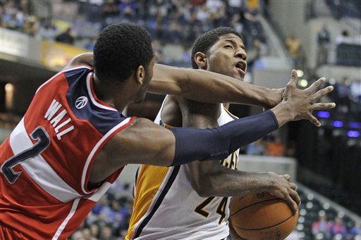 Indiana Pacers' Paul George is fouled by Washington Wizards' John Wall during the second half of an NBA basketball game Thursday, March 29, 2012, in Indianapolis. Indiana won 93-89. (AP Photo/Darron Cummings)