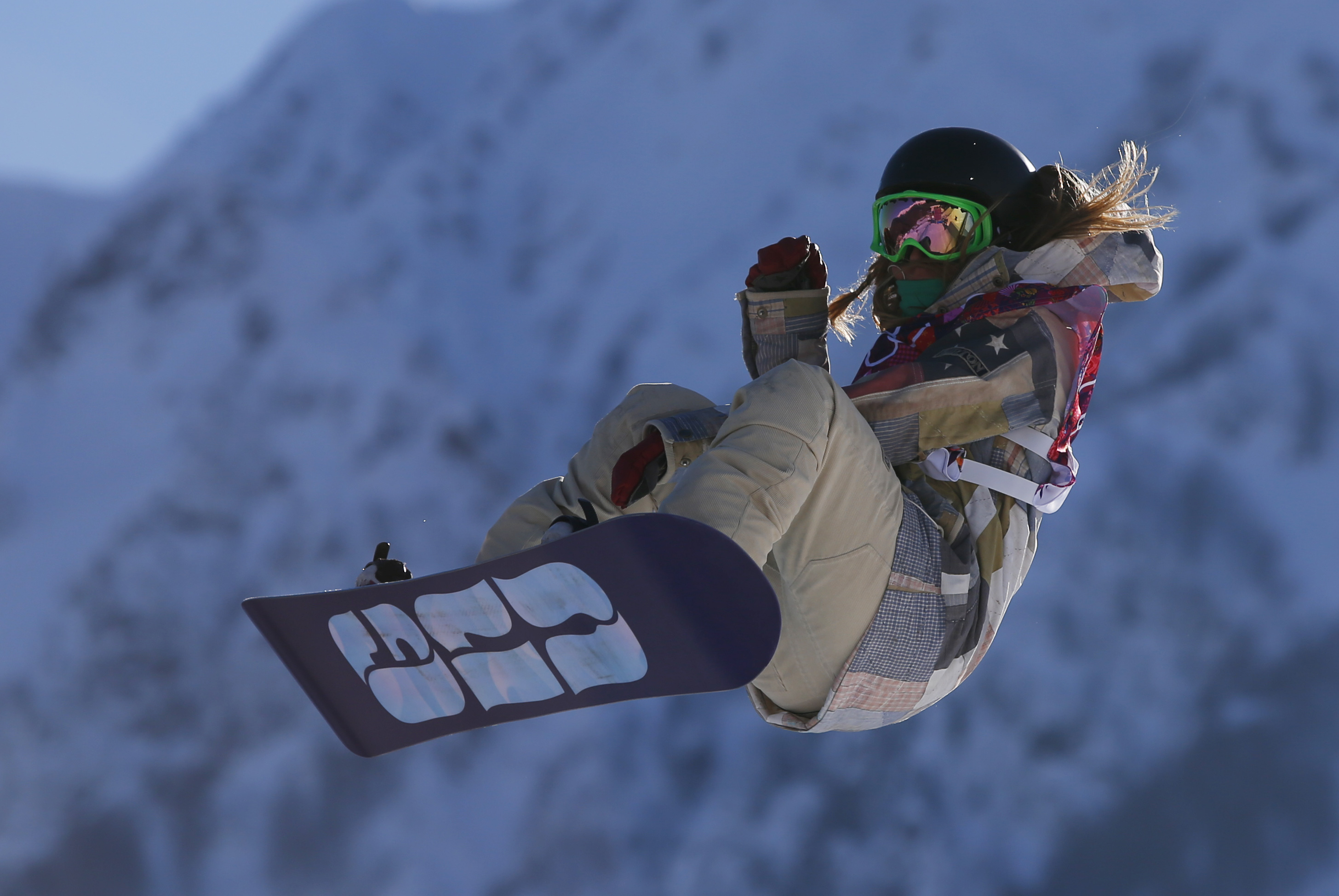 United States' Jamie Anderson takes a jump during the women's snowboard slopestyle qualifying at the Rosa Khutor Extreme Park ahead of the 2014 Winter Olympics, Thursday, Feb. 6, 2014, in Krasnaya Polyana, Russia. (AP Photo/Sergei Grits)
