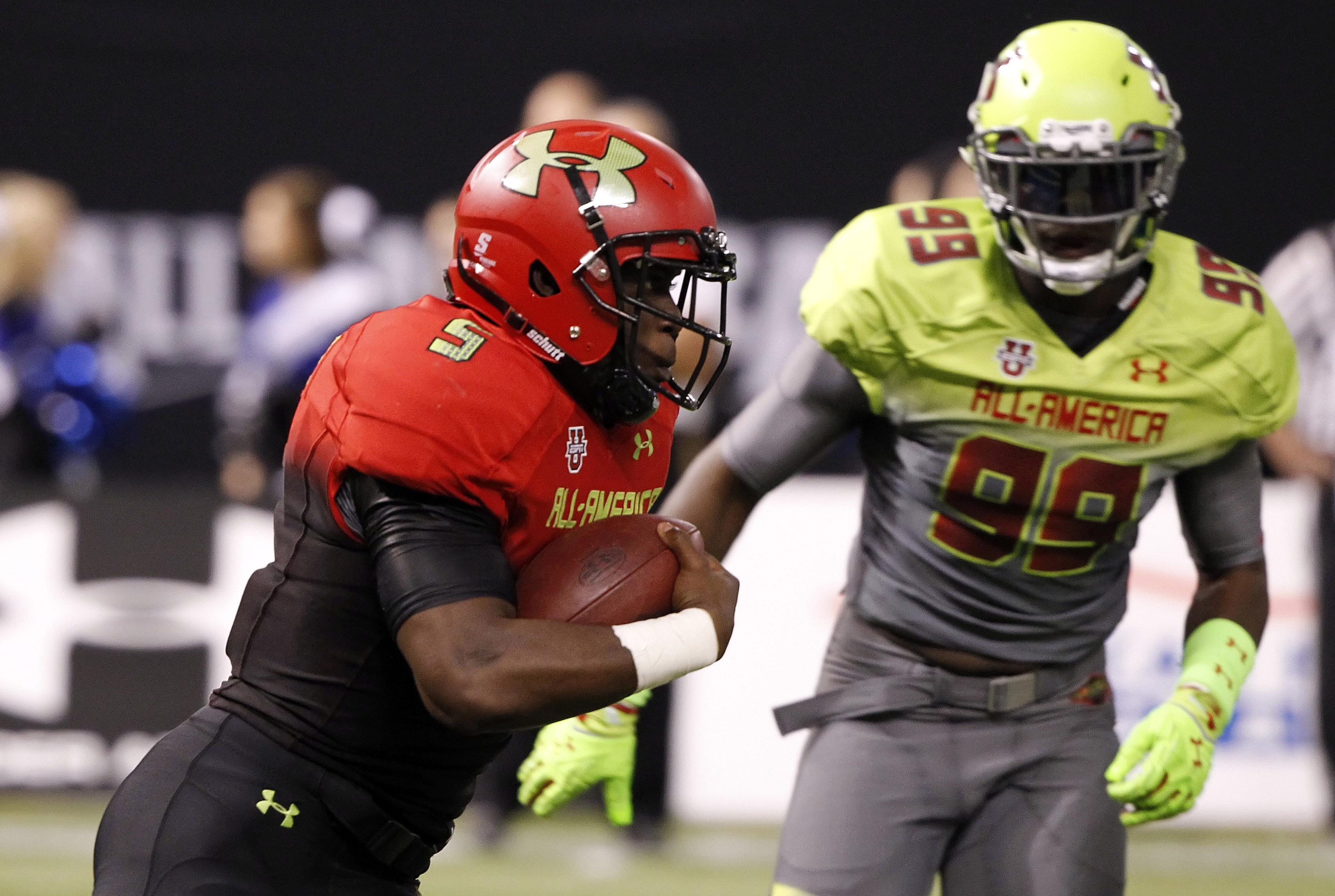 Jan 2, 2014; St. Petersburg, FL, USA; Team Highlight running back Leonard Fournette (5) runs with the ball during the first half as Team Nitro defensve end Chad Thomas (99) defends in the Under Armour All America football game at Tropicana Field. Mandatory Credit: Kim Klement-USA TODAY Sports