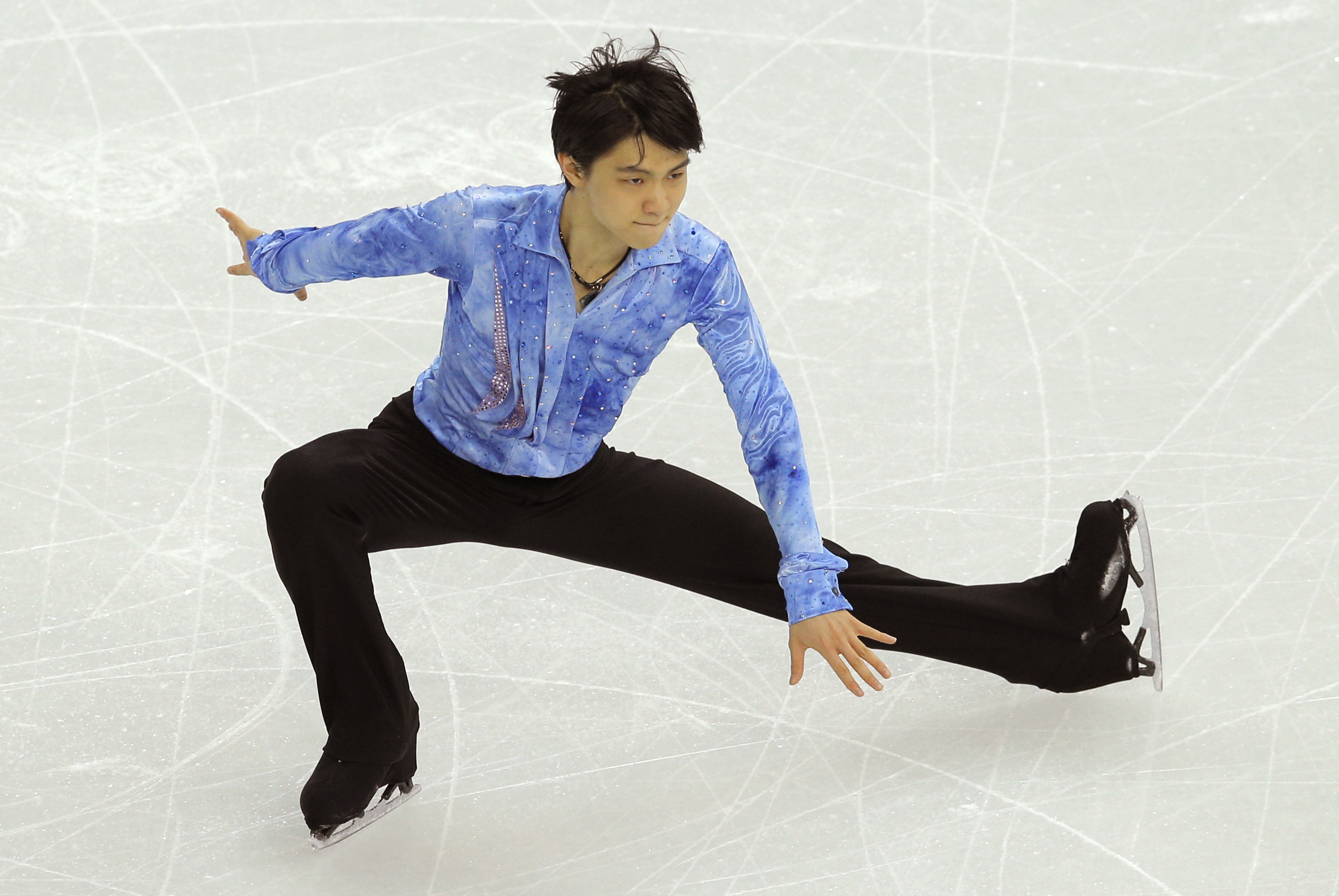 Yuzuru Hanyu of Japan competes in the men's team short program figure skating competition at the Iceberg Skating Palace during the 2014 Winter Olympics, Thursday, Feb. 6, 2014, in Sochi, Russia. (AP Photo/Vadim Ghirda)