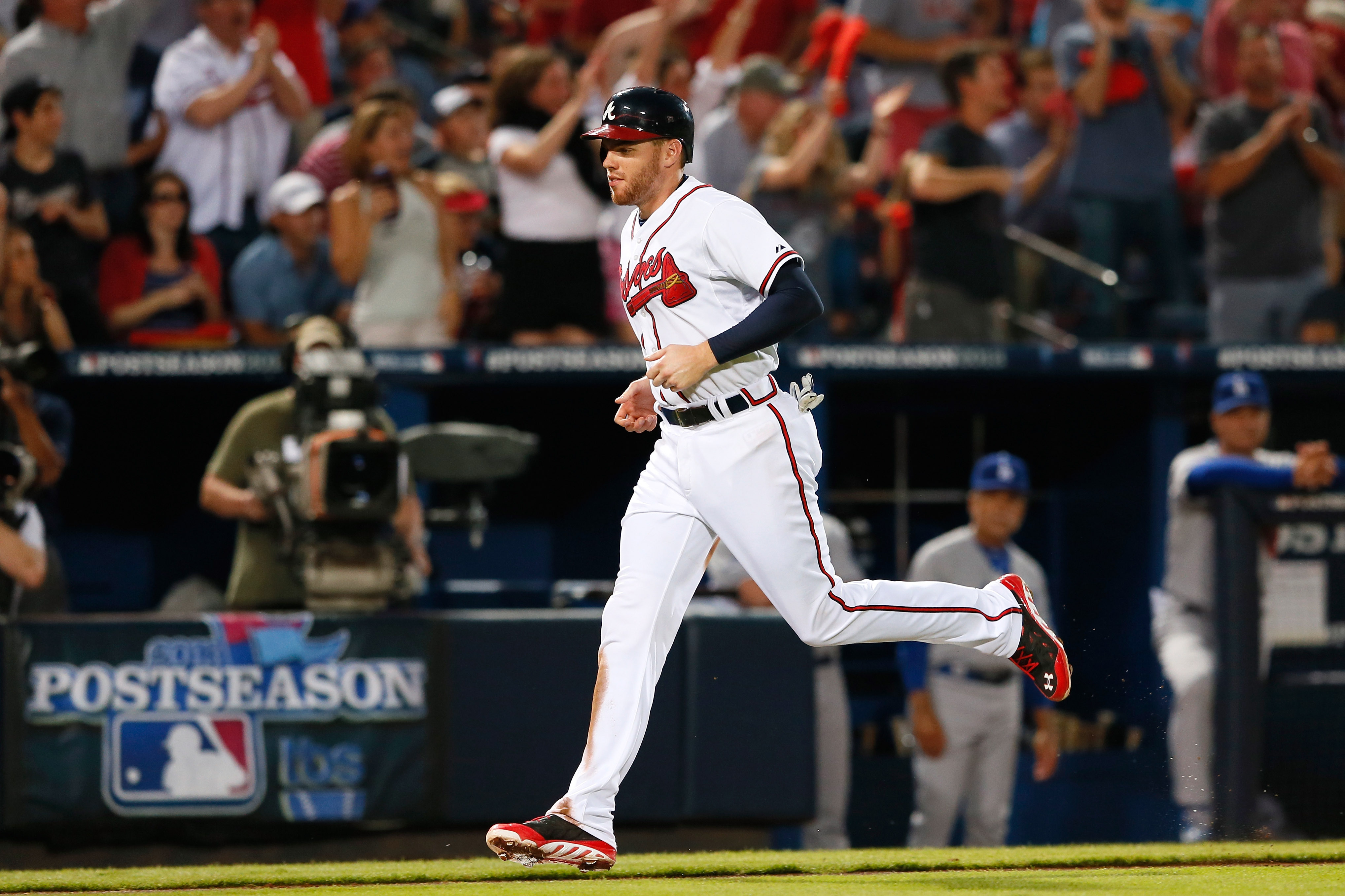 ATLANTA, GA - OCTOBER 04:  Freddie Freeman #5 of the Atlanta Braves scores off a single by Chris Johnson #23 in the fourth inning against the Los Angeles Dodgers during Game Two of the National League Division Series at Turner Field on October 4, 2013 in Atlanta, Georgia.  (Photo by Kevin C. Cox/Getty Images)