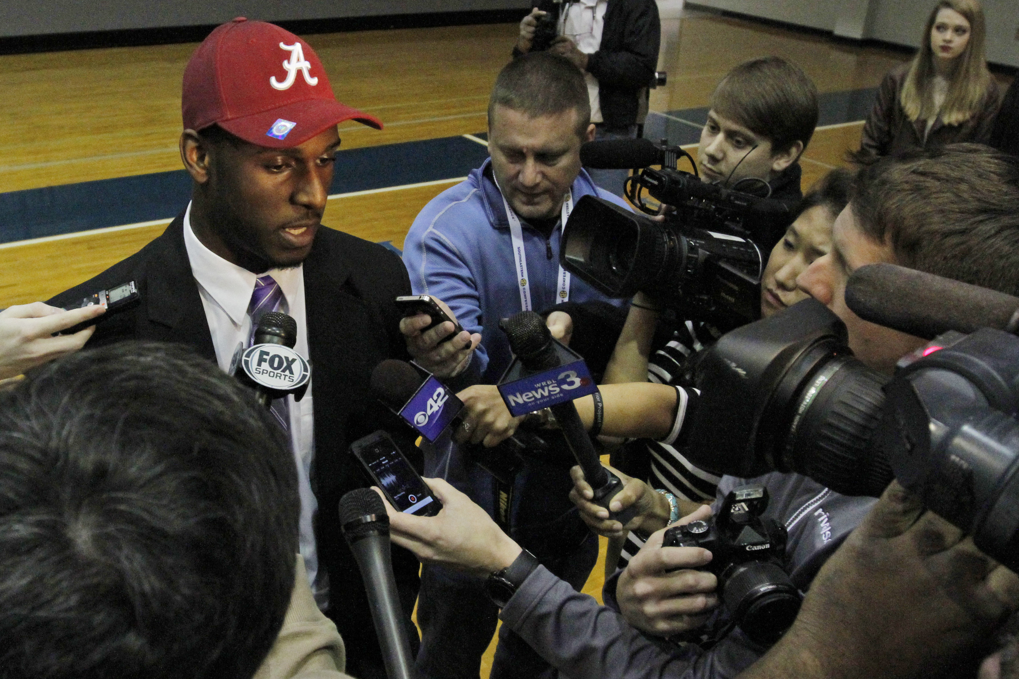 Rashaan Evans talks with the media after the Auburn High School football player announced that he will attend Alabama during a national signing day ceremony on Wednesday, Feb. 5, 2014, in Auburn, Ala. (AP Photo/Butch Dill)