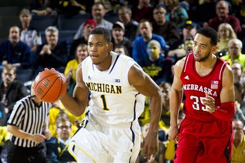 Michigan forward Glenn Robinson III (1) sprints downcourt pursued by Nebraska forward Walter Pitchford (35) in the second half of an NCAA college basketball game in Ann Arbor, Mich., Wednesday, Feb. 5, 2014. Michigan won 79-50. (AP Photo/Tony Ding)