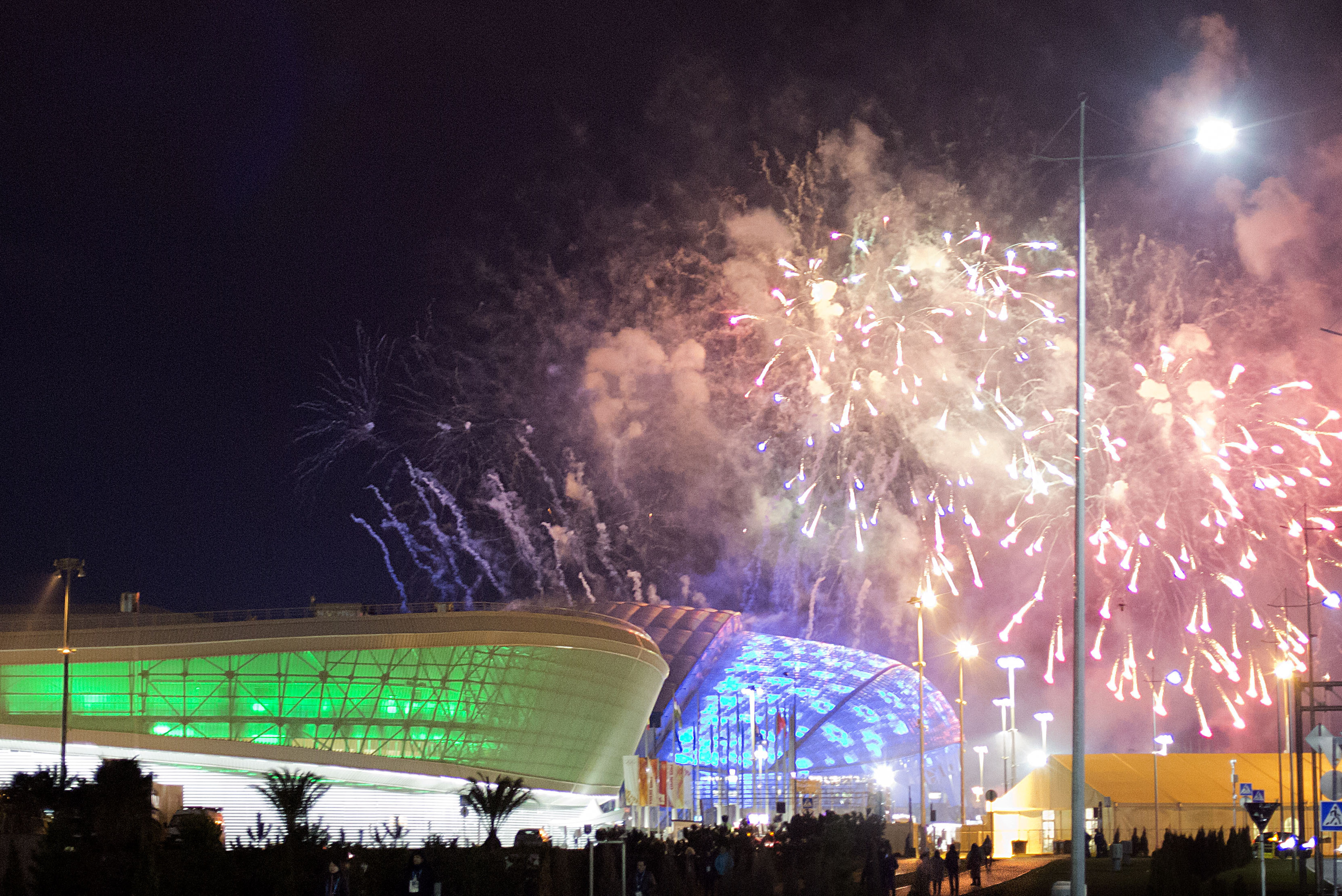 Fireworks are shot over Fisht Olympic Stadium, right, and Adler Arena, left, at the conclusion of a rehearsal for the opening ceremony at the 2014 Winter Olympics, Saturday, Feb. 1, 2014, in Sochi, Russia. (AP Photo/David Goldman)