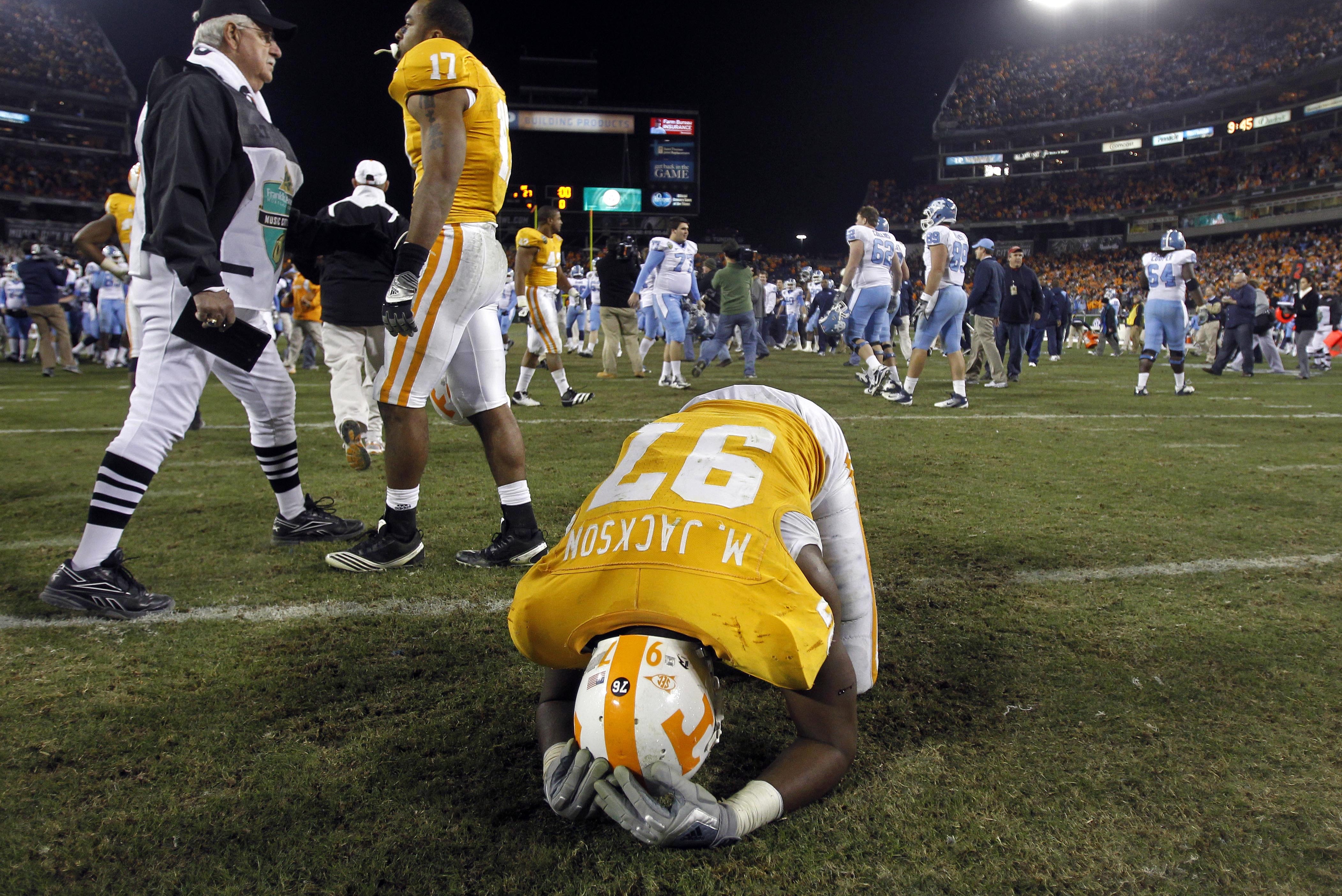 Tennessee defensive end Malik Jackson (97) kneels on the field after losing to North Carolina 30-27 in double overtime in the Music City Bowl NCAA college football game on Thursday, Dec. 30, 2010, in Nashville, Tenn. (AP Photo/Mark Humphrey)