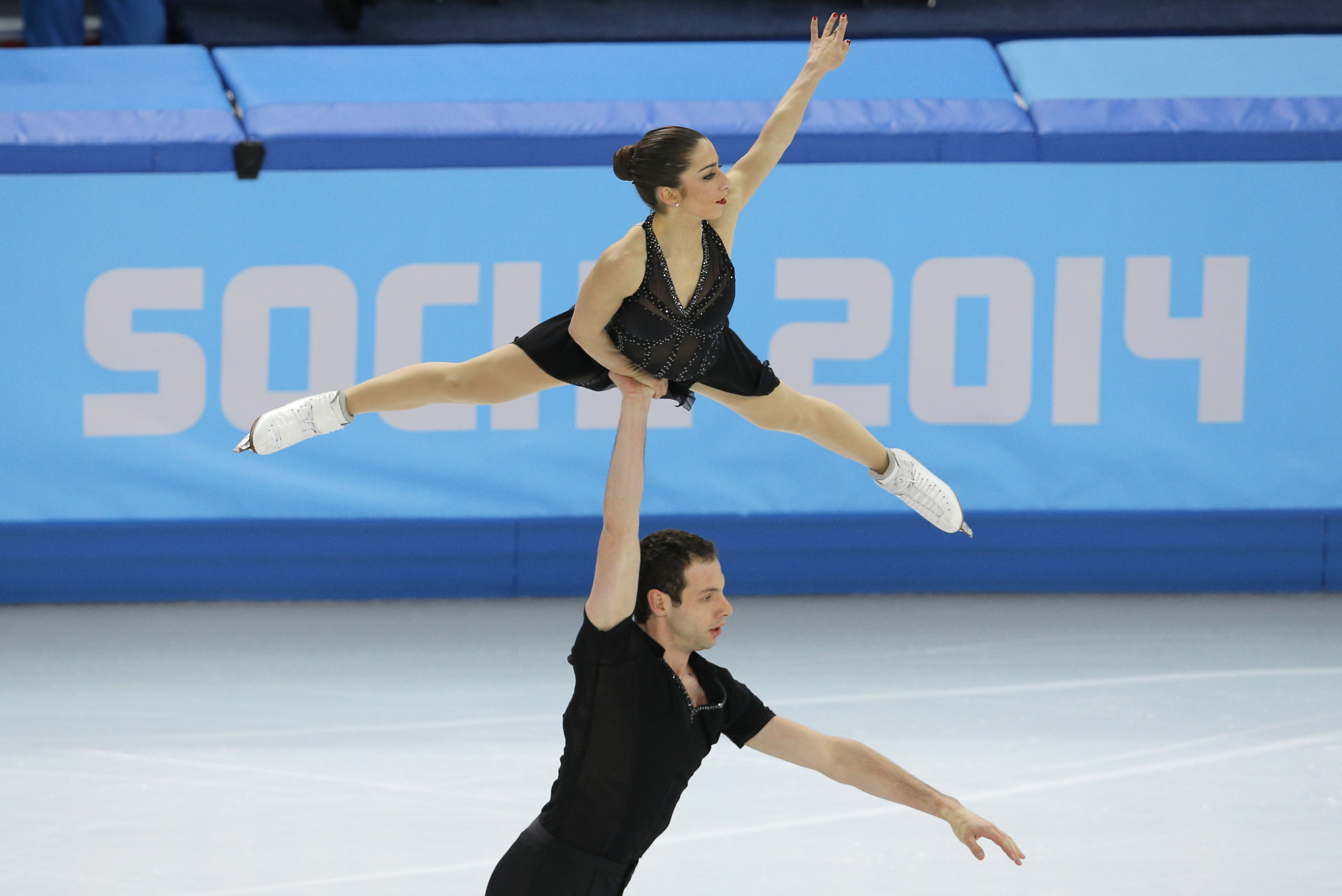 Marissa Castelli and Simon Shnapir of the United States compete in the team pairs short program figure skating competition at the Iceberg Skating Palace during the 2014 Winter Olympics, Thursday, Feb. 6, 2014, in Sochi, Russia. (AP Photo/Vadim Ghirda)