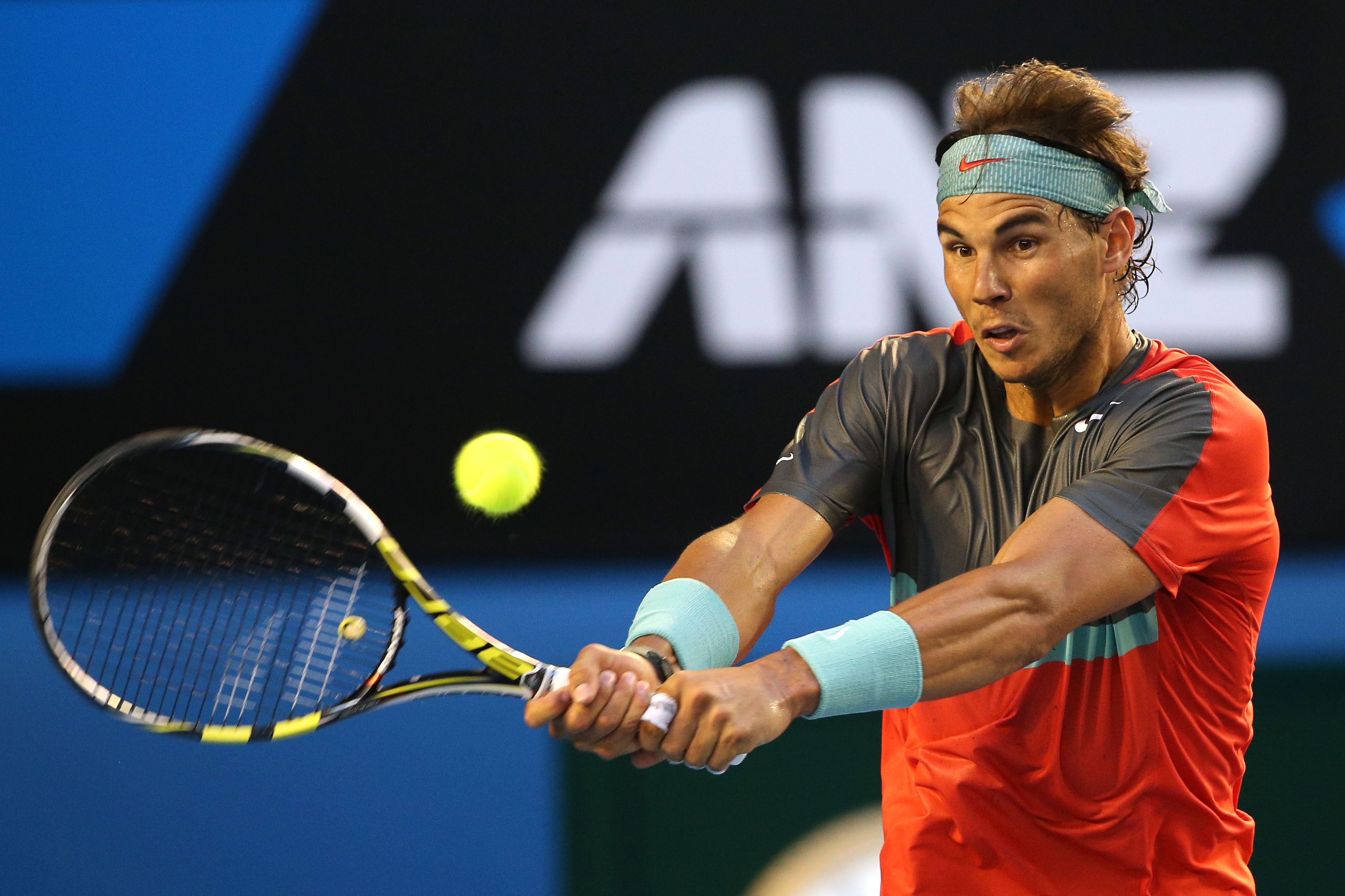 MELBOURNE, AUSTRALIA - JANUARY 26:  Rafael Nadal of Spain plays a backhand in his men's final match against Stanislas Wawrinka of Switzerland during day 14 of the 2014 Australian Open at Melbourne Park on January 26, 2014 in Melbourne, Australia.  (Photo by Clive Brunskill/Getty Images)