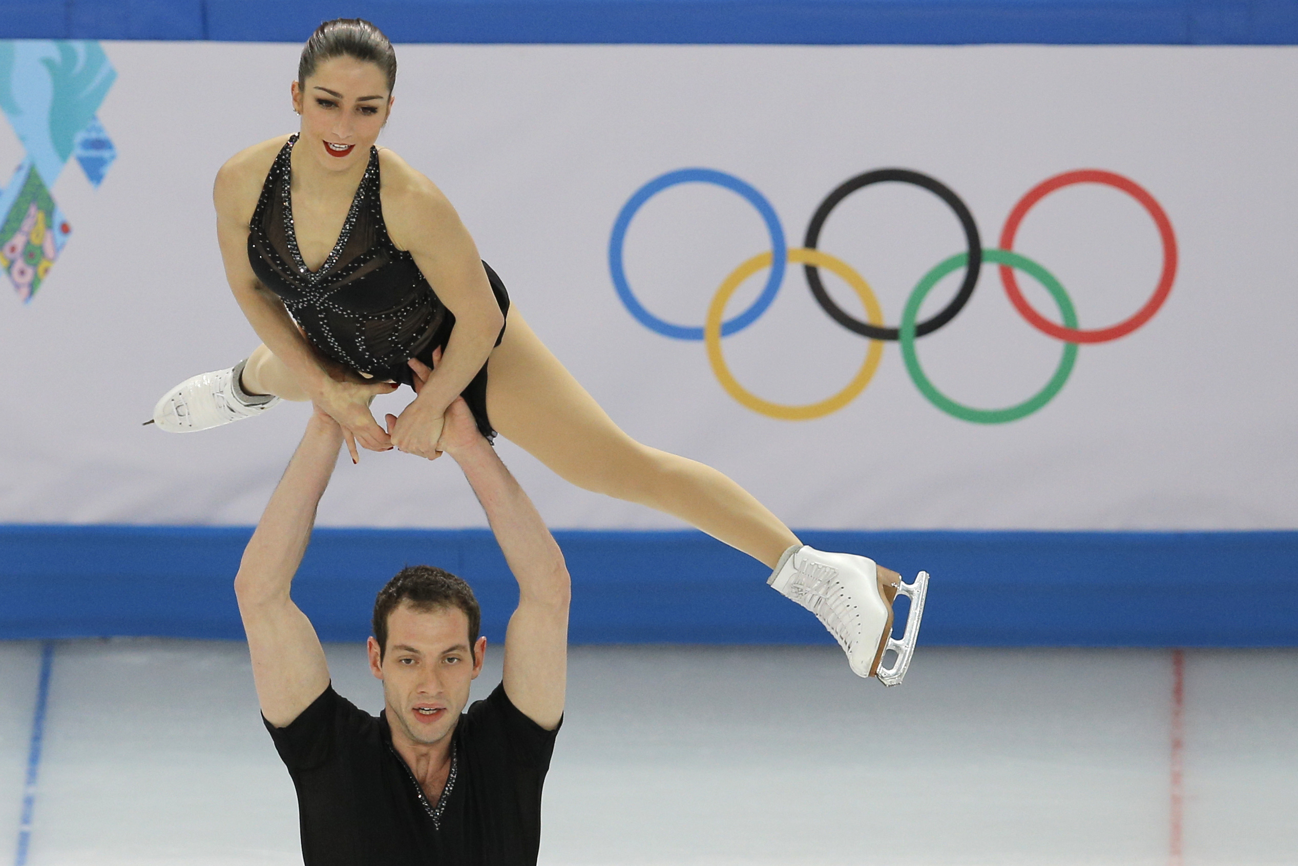 Marissa Castelli and Simon Shnapir of the United States compete in the team pairs short program figure skating competition at the Iceberg Skating Palace during the 2014 Winter Olympics, Thursday, Feb. 6, 2014, in Sochi, Russia. (AP Photo/Vadim Ghirda)