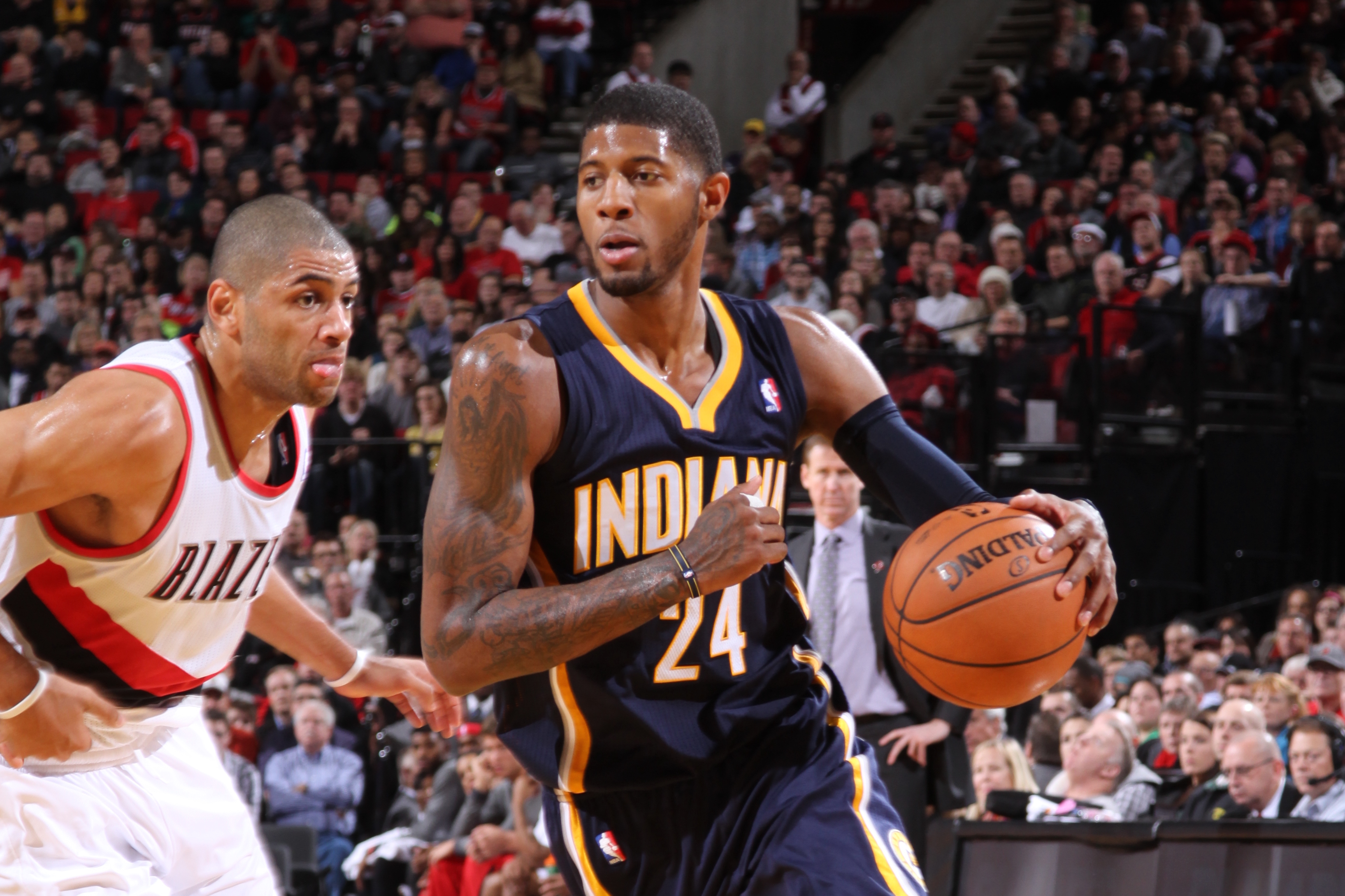 PORTLAND, OR - DECEMBER 2: Paul George #24 of the Indiana Pacers drives to the basket against Nicolas Batum #88 of the Portland Trail Blazers on December 2, 2013 at the Moda Center Arena in Portland, Oregon. NOTE TO USER: User expressly acknowledges and agrees that, by downloading and or using this photograph, user is consenting to the terms and conditions of the Getty Images License Agreement. Mandatory Copyright Notice: Copyright 2013 NBAE (Photo by Sam Forencich/NBAE via Getty Images)