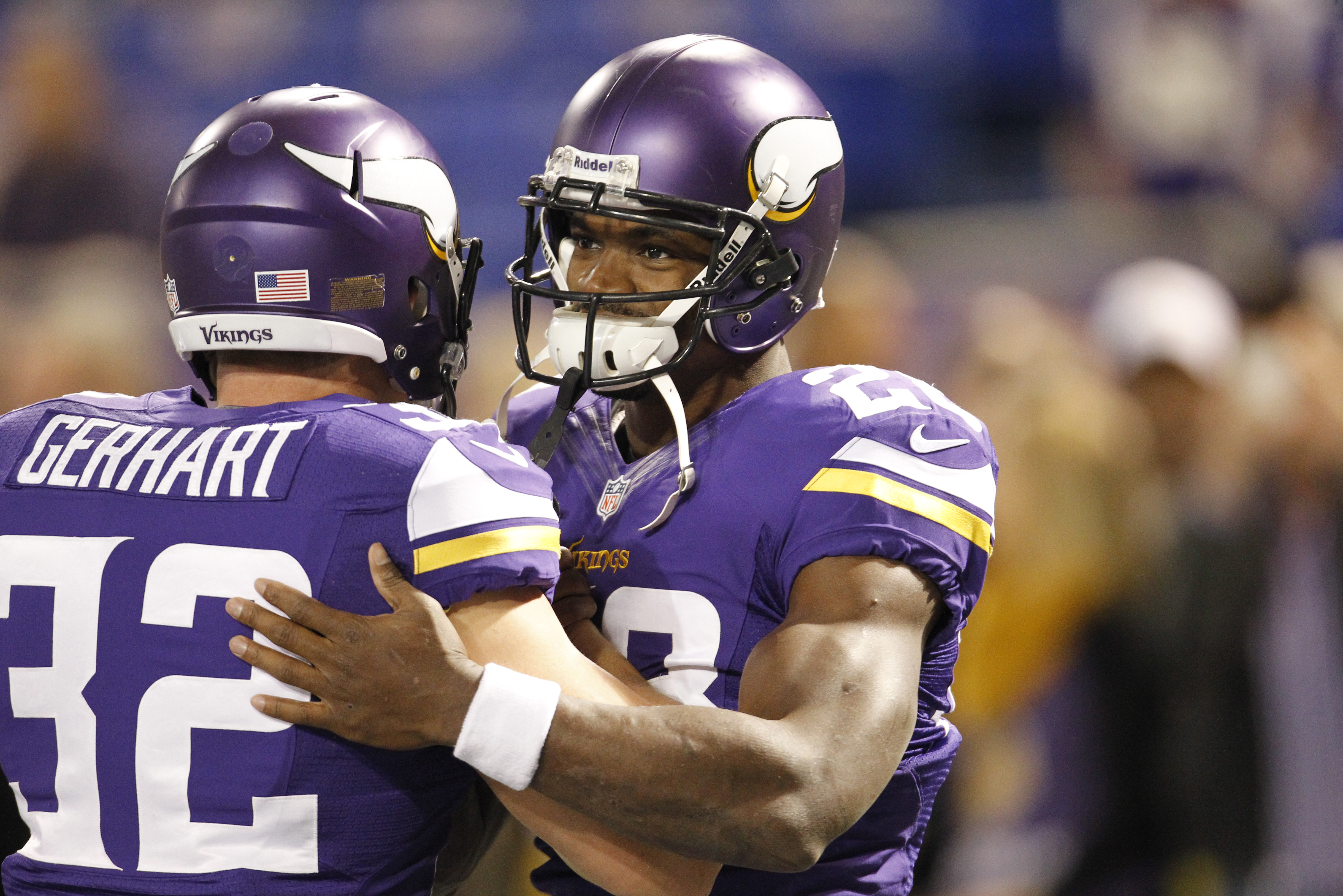 Minnesota Vikings running backs Adrian Peterson (28) talks to Toby Gerhart (32) before an NFL football game against the Green Bay Packers, Sunday, Oct. 27, 2013, in Minneapolis. (AP Photo/Ann Heisenfelt)