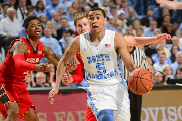 Feb 4, 2014; Chapel Hill, NC, USA; North Carolina Tar Heels guard Marcus Paige (5) drybbles as Maryland Terrapins guard Seth Allen (4) and forward Evan Smotrycz (1) defend in the second half. The North Carolina Tar Heels defeated the Maryland Terrapins 75-63 at Dean E. Smith Student Activities Center. Mandatory Credit: Bob Donnan-USA TODAY Sports