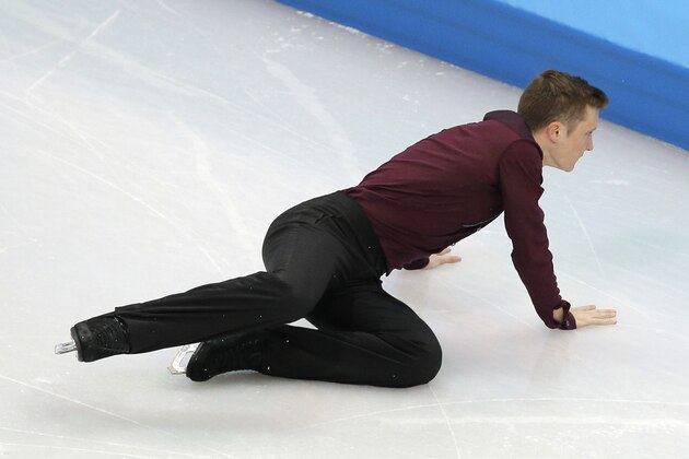 Jeremy Abbott of the United States falls as he competes in the men's team short program figure skating competition at the Iceberg Skating Palace during the 2014 Winter Olympics, Thursday, Feb. 6, 2014, in Sochi, Russia. (AP Photo/Vadim Ghirda)