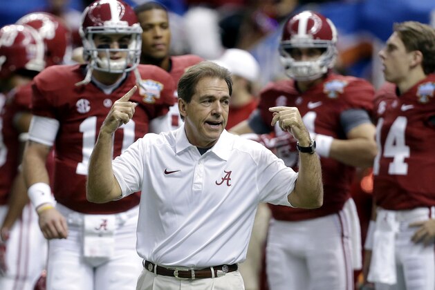 FILE - In this file photo from Jan. 2, 2014, Alabama head coach Nick Saban, center, calls drills as his team warms up before the NCAA college football Sugar Bowl against Oklahoma in New Orleans. The Southeastern Conference is still reigning supreme on the recruiting trail. The Crimson Tide is poised to bring in another top-rated recruiting class on Wednesday's, Feb. 5, 2014, national signing day. Six SEC rivals also have built top 10 classes, according to the 247Sports composite rankings of the major recruiting sites. (AP Photo/Rusty Costanza, File)