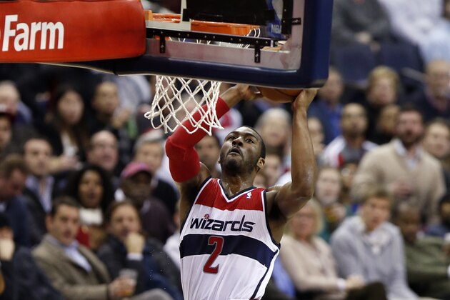 Washington Wizards guard John Wall (2) dunks the ball in the second half of an NBA basketball game against the Portland Trail Blazers, Monday, Feb. 3, 2014, in Washington. The Wizards won 100-90. (AP Photo/Alex Brandon)