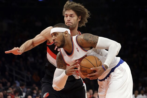 New York Knicks' Carmelo Anthony (7) drives past Portland Trail Blazers' Robin Lopez (42) during the first half of an NBA basketball game, Wednesday, Feb. 5, 2014, in New York. (AP Photo/Frank Franklin II)