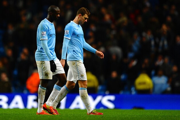MANCHESTER, ENGLAND - FEBRUARY 03:  A dejected Yaya Toure of Manchester City and Edin Dzeko of Manchester City leave the field at the final whistle during the Barclays Premier League match between Manchester City and Chelsea at Etihad Stadium on February 3, 2014 in Manchester, England.  (Photo by Laurence Griffiths/Getty Images)
