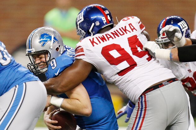 DETROIT, MI - DECEMBER 22: Matthew Stafford #9 of the Detroit Lions is sacked in the fourth quarter by Mathias Kiwanuka #94 of the New York Giants at Ford Field on December 22, 2013 in Detroit, Michigan. New York won the game in overtime 23-20. (Photo by Gregory Shamus/Getty Images)