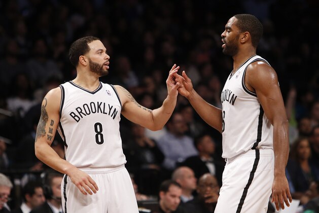 Brooklyn Nets' Deron Williams (8) celebrates with teammate Alan Anderson during the second half of an NBA basketball game against the San Antonio Spurs, Thursday, Feb. 6, 2014, in New York. Brooklyn won 103-89. (AP Photo/Jason DeCrow)
