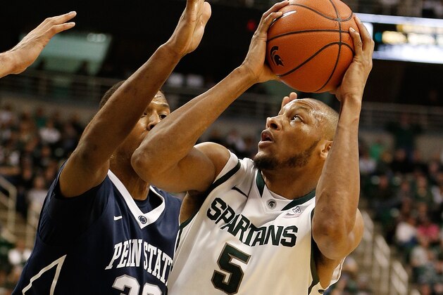 EAST LANSING, MI - FEBRUARY 06:  Adreian Payne #5 of the Michigan State Spartans tries to get a second-half shot off around Jordan Dickerson #32 of the Penn State Nittany Lions at the Jack T. Breslin Student Events Center on February 6, 2014 in East Lansing, Michigan. Michigan State won the game 82-67. (Photo by Gregory Shamus/Getty Images)