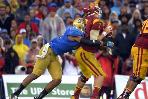 UCLA linebacker Anthony Barr, left, sacks Southern California quarterback Matt Barkley during the second half of their NCAA college football game, Saturday, Nov. 17, 2012, in Pasadena, Calif. UCLA won 38-28. (AP Photo/Mark J. Terrill)