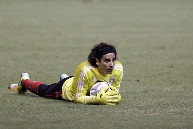 Mexico's goalkeeper Guillermo Ochoa lies on the pitch during a training session ahead of a 2014 World Cup qualifying soccer match against Costa Rica, in San Jose, Costa Rica, Monday, Oct. 14, 2013. (AP Photo/Moises Castillo)