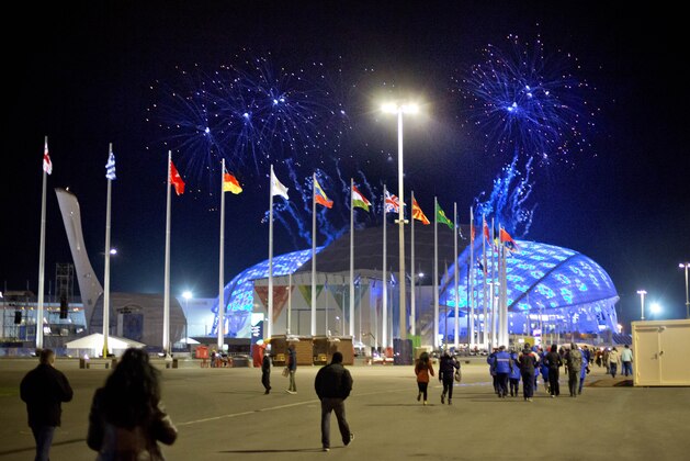 Fireworks are seen as spectators arrive for the rehearsal of the opening ceremony at the Fisht Olympic Stadium at the 2014 Winter Olympics, Saturday, Feb. 1, 2014, in Sochi, Russia. (AP Photo/David Goldman)