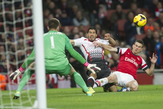 Liverpool's Luis Suárez tries to score past Arsenal's Wojciech Szczesny (left) and Laurent Koscielny (right) during their English Premier League soccer match, at the Emirates Stadium, in London, Saturday, Nov. 2, 2013. (AP Photo/Bogdan Maran)