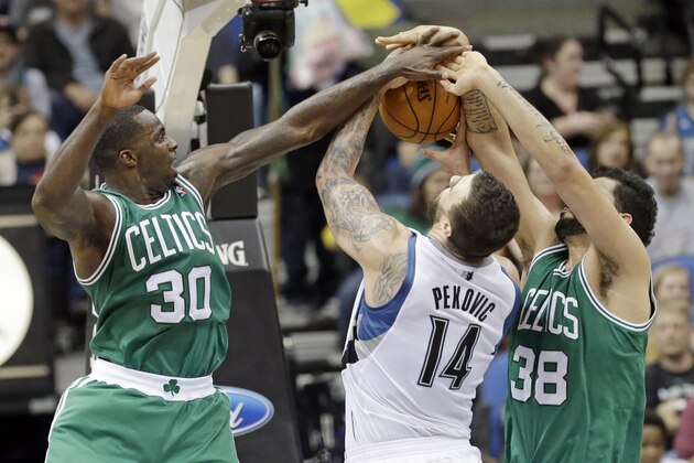 Minnesota Timberwolves' Nikola Pekovic (14), of Montenegro, tries to keep control of the ball as Boston Celtics' Brandon Bass, left, and Vitor Faverani, of Brazil, defend in the second half of an NBA basketball game on Saturday, Nov. 16, 2013, Minneapolis. The Timberwolves won 106-88. (AP Photo/Jim Mone)