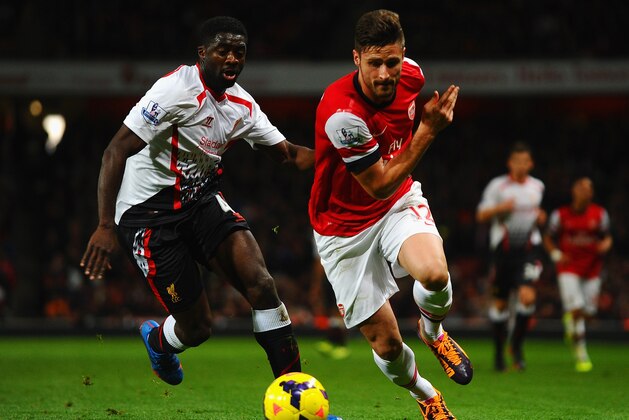 LONDON, ENGLAND - NOVEMBER 02: Kolo Toure of Liverpool marshalls Olivier Giroud of Arsenal during the Barclays Premier League match between Arsenal and Liverpool at Emirates Stadium on November 2, 2013 in London, England.  (Photo by Laurence Griffiths/Getty Images)