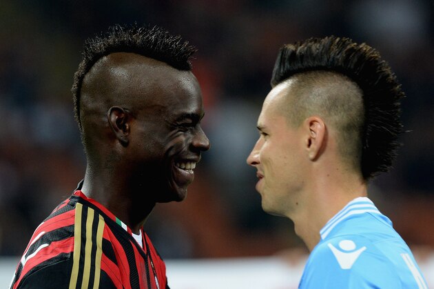 MILAN, ITALY - SEPTEMBER 22:  Mario Balotelli of AC Milan (L) and Marek Hamsik of SSC Napoli during the Serie A match between AC Milan and SSC Napoli at San Siro Stadium on September 22, 2013 in Milan, Italy.  (Photo by Claudio Villa/Getty Images)