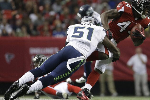 Atlanta Falcons fullback Jason Snelling (44) runs against Seattle Seahawks outside linebacker Bruce Irvin (51) during the first half of an NFL football game, Sunday, Nov. 10, 2013, in Atlanta. (AP Photo/David Goldman)