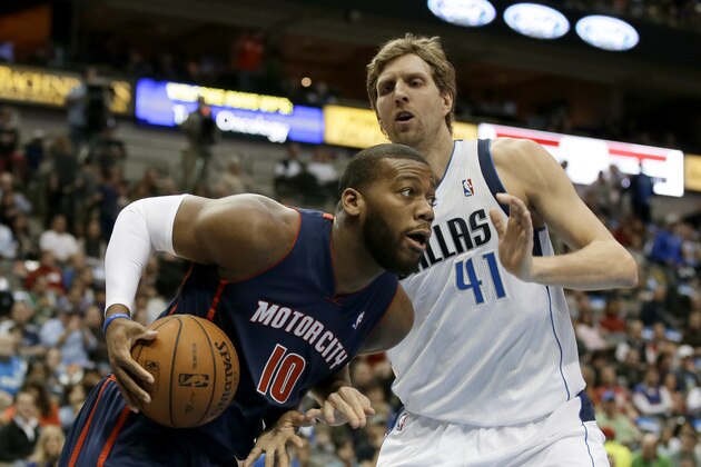 Detroit Pistons power forward Greg Monroe (10) drives around Dallas Mavericks' Dirk Nowitzki (41) of Germany during an NBA basketball game, Sunday, Jan. 26, 2014, in Dallas. The Mavericks won 116-106. (AP Photo/Tony Gutierrez)