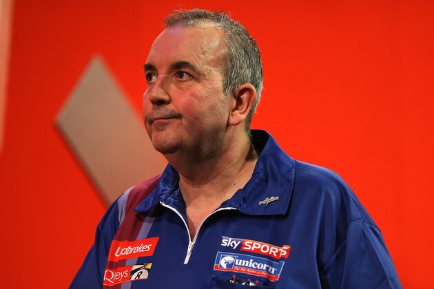 LONDON, ENGLAND - DECEMBER 20: Phil Taylor of England reacts as he walks off the stage after losing his second round match to Michael Smith of England during the Ladbrokes.com World Darts Championship on Day Eight at Alexandra Palace on December 20, 2013 in London, England. (Photo by Charlie Crowhurst/Getty Images)