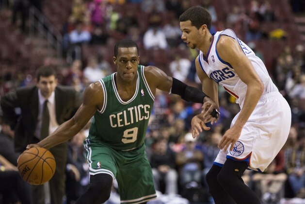 Boston Celtics' Rajon Rondo, left, looks to make his move on Philadelphia 76ers' Michael Carter-Williams, right during the second half of an NBA basketball game, Wednesday, Feb. 5, 2014, in Philadelphia. The Celtics won 114-108. (AP Photo/Chris Szagola)