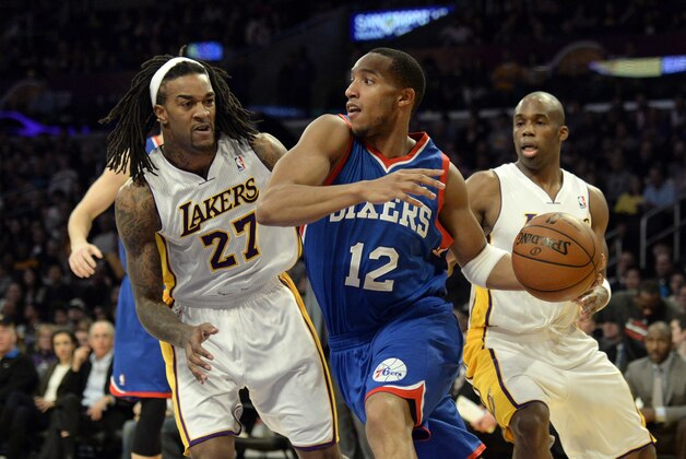 Dec 29, 2013; Los Angeles, CA, USA; Philadelphia 76ers small forward Evan Turner (12) looks to pass under pressure from Los Angeles Lakers center Jordan Hill (27) during the first quarter at Staples Center. Mandatory Credit: Richard Mackson-USA TODAY Sports