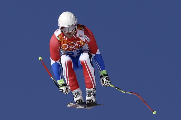 France's David Poisson makes a jump during a men's downhill training run for the Sochi 2014 Winter Olympics, Friday, Feb. 7, 2014, in Krasnaya Polyana, Russia.(AP Photo/Luca Bruno)