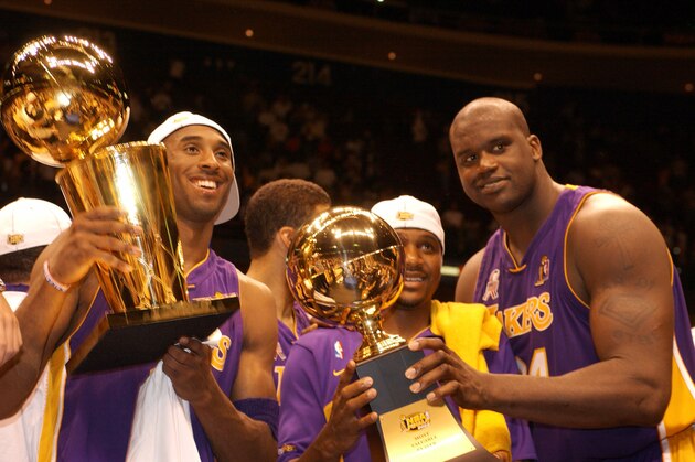 EAST RUTHERFORD, NJ - JUNE 12: Kobe Bryant #8, Lindsey Hunter and Shaquille O'Neal #34 of the Los Angeles Lakers celebrate after winning the 2002 NBA Championship against the New Jersey Nets at the Continental Airlines Arena on June 12, 2002 in East Rutherford, New Jersey.  NOTE TO USER: User expressly acknowledges  and agrees that, by downloading and or using this  photograph, User is consenting to the terms and conditions of the Getty Images License Agreement. Mandatory copyright notice: Copyright NBAE 2002 (Photo by Garrett W. Ellwood/ NBAE/ Getty Images)