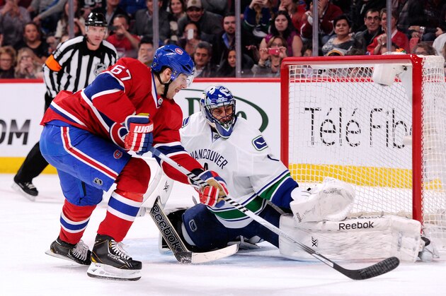 MONTREAL, QC - FEBRUARY 6:  Roberto Luongo #1 of the Vancouver Canucks stops the penalty shot attempt by Max Pacioretty #67 of the Montreal Canadiens during the NHL game at the Bell Centre on February 6, 2014 in Montreal, Quebec, Canada.  (Photo by Richard Wolowicz/Getty Images)