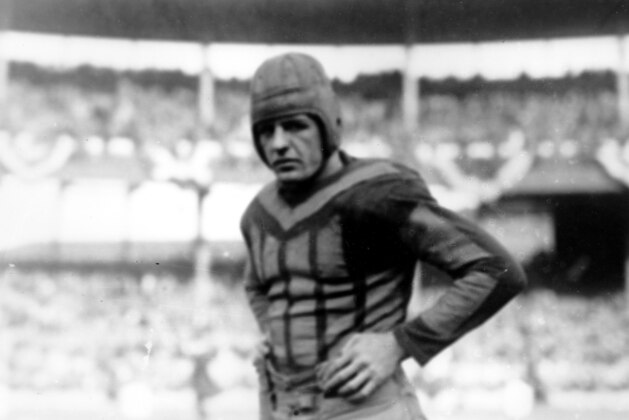 American football player Red Grange of the Chicago Bears is shown during a game against the New York Giants in New York in 1925. The running back is known as the
