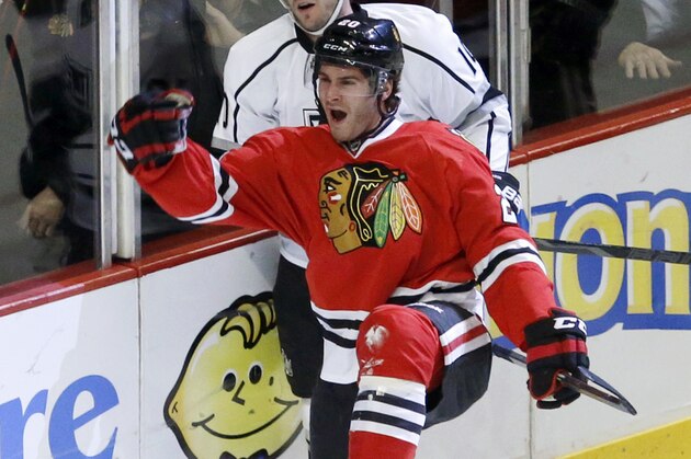 Chicago Blackhawks left wing Brandon Saad (20) celebrates his goal as Los Angeles Kings center Mike Richards skates behind during the first period of an NHL hockey game Monday, Dec. 30, 2013, in Chicago. (AP Photo/Charles Rex Arbogast)