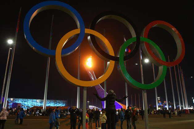 SOCHI, RUSSIA - FEBRUARY 07:  The flame is seen through the Olympic Rings after the Opening Ceremony of the Sochi 2014 Winter Olympics at Fisht Olympic Stadium on February 7, 2014 in Sochi, Russia.  (Photo by Robert Cianflone/Getty Images)