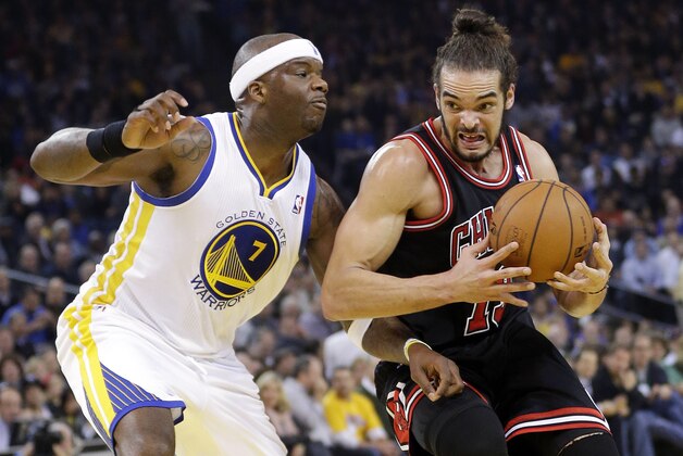 Chicago Bulls' Joakim Noah (13) dribbles next to Golden State Warriors' Jermaine O'Neal (7) during the first half of an NBA basketball game, Thursday, Feb. 6, 2014, in Oakland, Calif. (AP Photo/Marcio Jose Sanchez)