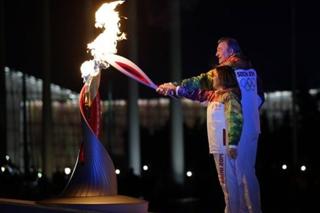 Irina Rodnina and Vladislav Tretiak light the Olympic cauldron during the opening ceremony of the 2014 Winter Olympics in Sochi, Russia, Friday, Feb. 7, 2014. (AP Photo/Matt Slocum, Pool)