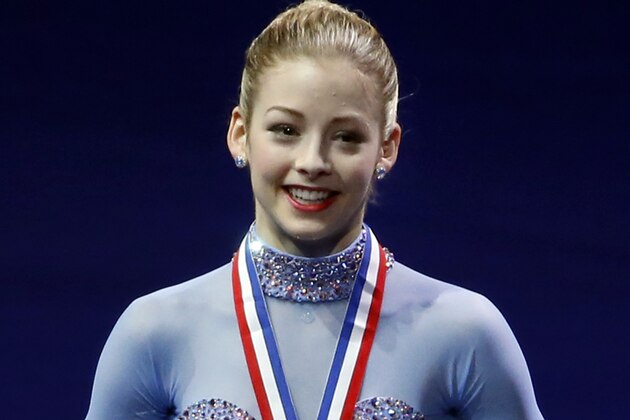 Gracie Gold holds her gold medal on the podium at the women's skating awards ceremony at the U.S. Figure Skating Championships in Boston, Saturday, Jan. 11, 2014. (AP Photo/Elise Amendola)